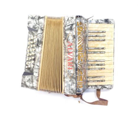 An Alvari piano accordion, cased with instruction book.