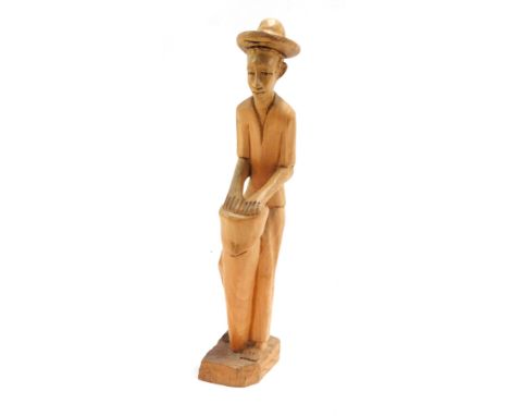 Tribal Art. A carved wooden figure, playing a bongo drum, 41cm high.