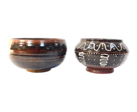 Two Studio Pottery bowls, comprising a light and dark brown glazed finish ribbed bowl, 22cm high, and a brown and white swirl