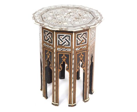 An early 20thC Damascus type mother of pearl inlaid table, the top raised on panelled sides, with mihrabs, on tapering straig