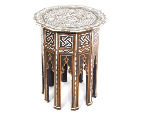 An early 20thC Damascus type mother of pearl inlaid table, the top raised on panelled sides, with mihrabs, on tapering straig