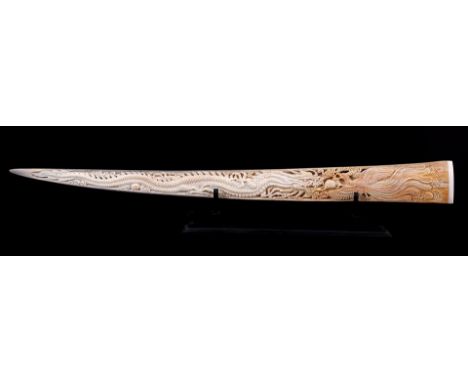 Swordfish tusk with finely hand-carved figure of the dragon and phoenix in Feng Shui on a blackened wooden tripod, 77 cm long