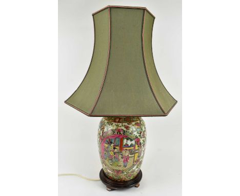 A Qing dynasty Canton famille rose cermaic lamp with hexagonal shade. The elongated ovoid shaped lamp base decorated with han