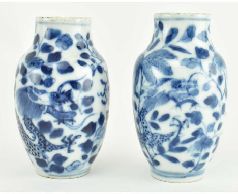A pair of blue and white ceramic miniature vases. Each vase has a baluster shape decorated with Dragon amidst peonies and lea
