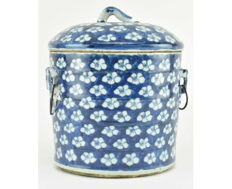 A Qing dynasty blue and white ceramic lidded prunus jar. The cylindrical jar modelled as made of bamboo, painted with prunus 