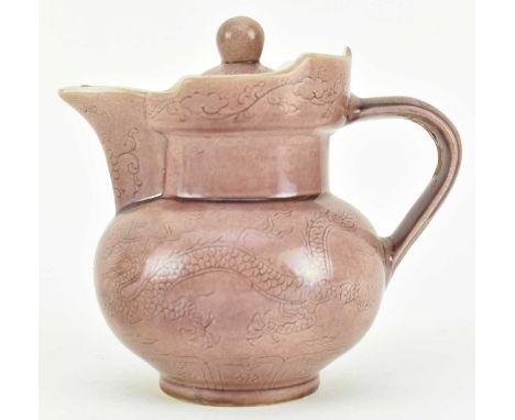 A ceramic lidded monk's hat ewer. The light aubergine glazed ewer potted with a bulbous body raised on a short foot, decorate