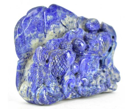 A carved lapis lazuli boulder, depicting two gold fishes in a lotus pond.Meaures approx. 11cm tall x 16cm long.