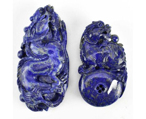 Two carved lapis lazuli pieces. The lot to include a carved dragon boulder and a lion standing on a ball boulder / pendant.Lo