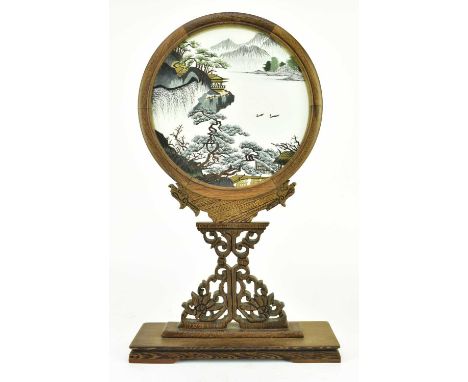 A 20th century wood encased double side embroidery screen under glass with stand. The swival stand carved with two dragon's h