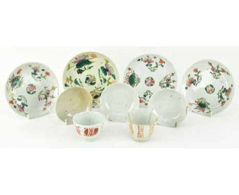 A group of nine pieces of copper-red and polychrome ceramic teacups and saucers. The lot to a teacup decorated with fruit, ba