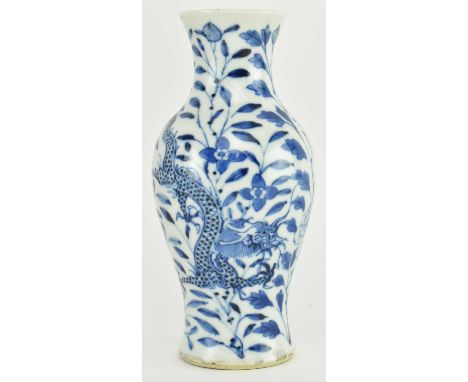 A small Qing dynasty blue and white ceramic vase. The baluster shaped vase decorated with two four-clawed dragons amidst peon