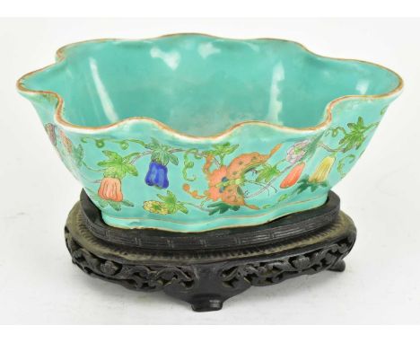 A Qing dynasty turquoise ground famille rose ceramic scalloped bowl. The leaf shaped bowl modelled with scallop rim, featurin