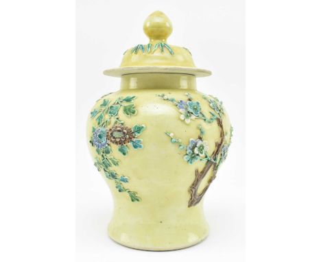 A late Qing dynasty yellow ground "Floral" relief ceramic vase. The baluster shaped vase decorated with relief cherry blossom