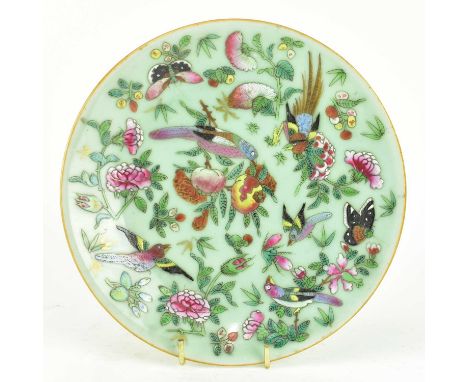 A Qing dynasty Tongshi period ceramic celadon plate. The circular plate deoctated with birds, butterflies, flowers and fruits