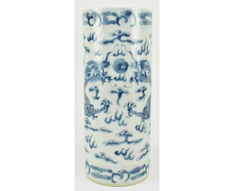 A Qing dynasty blue and white ceramic sleeve vase. The cylindrical vase decorated with two four clawed dragons chasing a flam