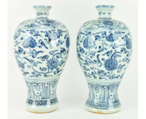 A pair of Ming dynasty or late blue and white ceramic meiping vases. Each vase modelled in a baluster form rising from a broa