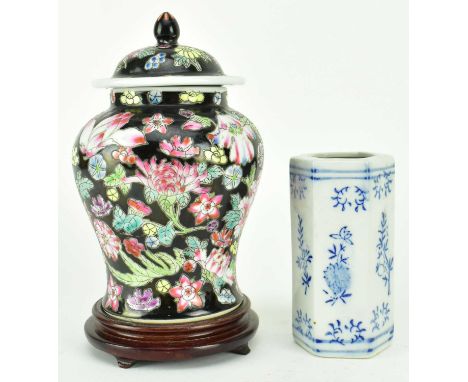 Two 20th century ceramic pieces. The lot comprising a black ground baluster vase decorated with mille fleur floral motif, wit