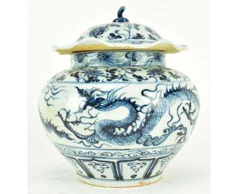 A Yuan dynasty blue or later and white ceramic jar with cover. The baluster shaped vase decorated with floral scrolling on th