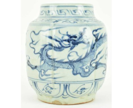 A Yuan dynasty blue and white ceramic jar. The ovoid form fluted jar / pot decorated with a three-clawed dragon surrounded by