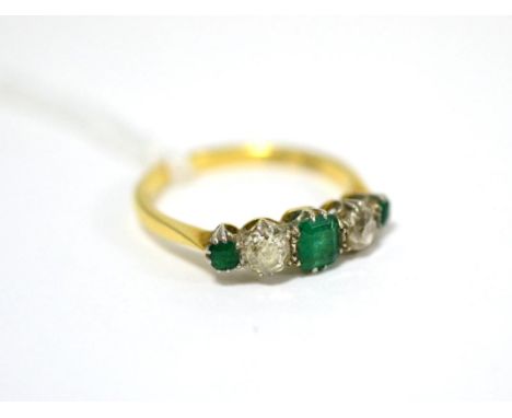 An emerald and diamond five stone ring, an emerald-cut emerald between two old cut diamonds and two round cut emeralds in whi