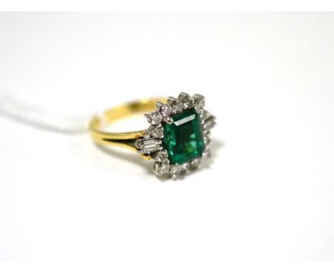 A synthetic emerald and diamond cluster ring, the emerald-cut emerald within a border of round brilliant cut and baguette cut