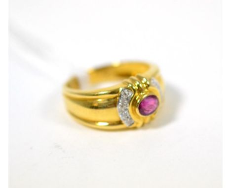 A ruby and diamond ring, an oval cut ruby in a yellow rubbed over setting, flanked by bands of white pavé set round brilliant