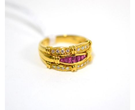 A ruby and diamond ring, with a central band of calibré cut rubies in yellow channel settings between two bands of round bril