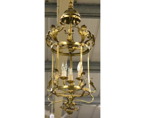 An Edwardian brass hall lantern, with leaf and scroll decoration, 77cm high, fitted for electricityDrilled for wiring.  Some 