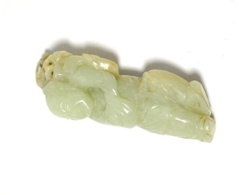 A jade carving of a young boy, to hang from a belt loop