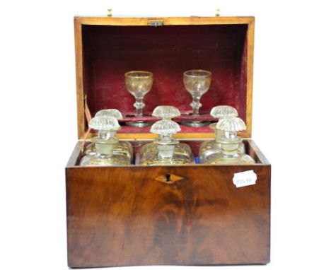 A George III mahogany six bottle decanter box, circa 1800, containing six gilt highlighted decanters and a pair of glassesBox