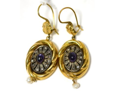 A pair of amethyst set earrings, a yellow floral motif suspends a yellow rope pattern frame inset with an oval cabochon ameth