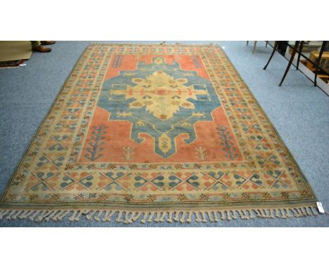 A Kozak carpet, West Anatolia, the ice blue field centred by an ivory medallion framed by madder spandrels and ivory borders 