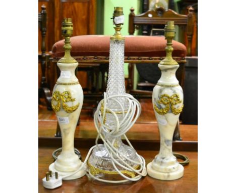A pair of white and grey marble table lamps with gilt metal ribbon swags, 46cm high and a cut glass gilt mounted table lamp, 