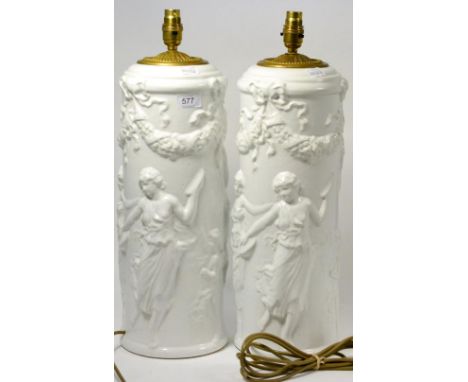 A pair of Italian pottery lamp bases moulded with dancing classical figures, 53cm high 
