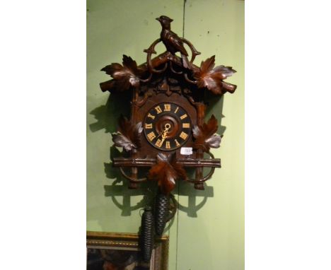 A Black Forrest cuckoo striking wall clock, circa 1890, floral and bird mounts, two cuckoo door apertures, side doors, 6-inch