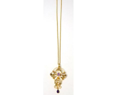 An amethyst and seed pearl brooch/pendant on chain, a round cut amethyst in yellow milled setting within a seed pearl set fra