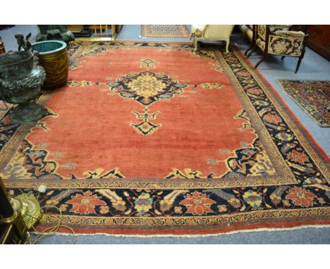 Sultanabad carpet, West Persia, the plain soft strawberry field centred by an indigo and ivory medallion enclosed by spandrel