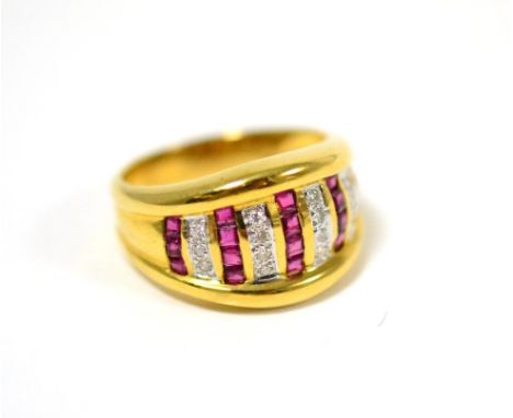 A ruby and diamond ring, vertical rows of step cut rubies alternate with rows of round brilliant cut diamonds, in yellow chan