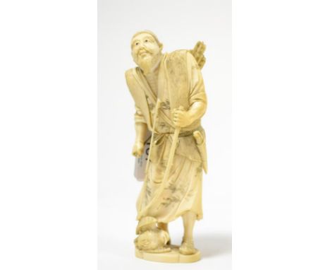 A Japanese ivory okimono of a hunter, Meiji period, a bird at his feet, 16cm highUpper part of bow broken but retained. Arrow