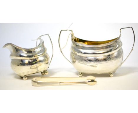 ^A George II silver milk jug, matching sugar bowl and sugar nips, possibly R & S Hennell, London 1805