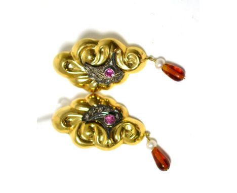 A pair of earrings, the fancy yellow scroll drops inset with a round cut ruby within a white millegrain rose cut diamond set 