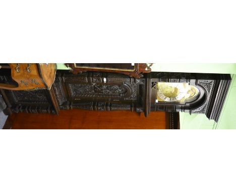 <A carved oak chiming longcase clock, circa 1880, the elaborately carved case with scroll and floral decoration, 12-inch arch