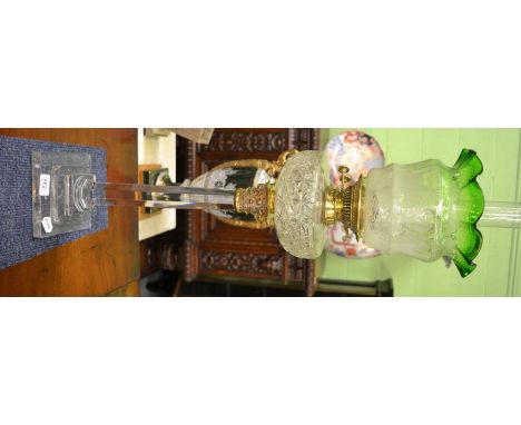 A good cut glass oil lamp with green shadeUnderside of glass base with scratching. Otherwise good condition overall.