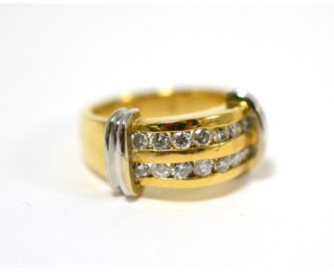 A diamond two row ring, round brilliant cut diamonds in yellow channel settings, with white bar shoulders, on a plain polishe