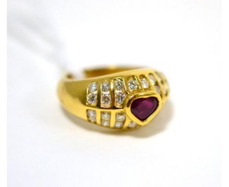 A ruby and diamond ring, a heart cut ruby in a yellow rubbed over setting, within a border of round brilliant cut diamonds in