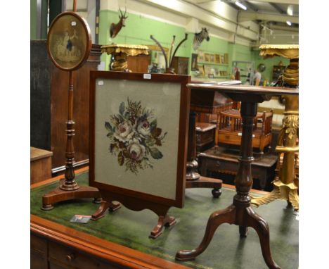 ^An early Victorian mahogany pole screen, circa 1840, a fire screen and a George III mahogany tilt top circular table, circa 