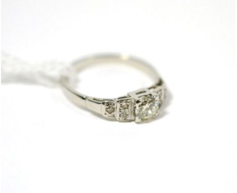 A diamond ring, an old cut diamond in a white four claw setting, to eight-cut diamond set stepped shoulders, on a plain polis