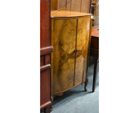 A 1930's walnut bow fronted linen chest 