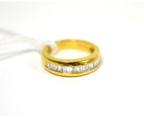 A diamond half hoop ring, baguette cut diamonds in a yellow channel setting, finger size KGood condition. Stamped to inner sh