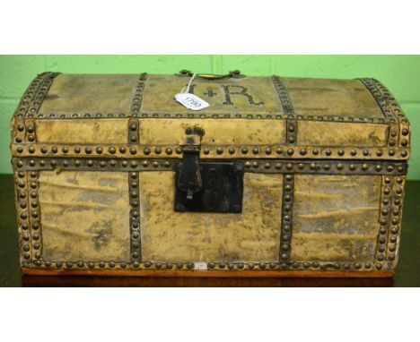 Hide covered domed small trunk, studded detail and initials J R, with paper lining and label ''Harrison'', travelling trunks,